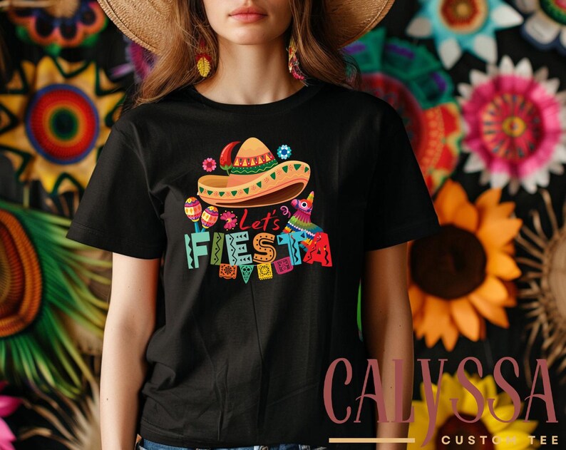 May include: A black t-shirt with a colorful graphic design that says 'Let's Fiesta' with a sombrero, maracas, and a pinata.