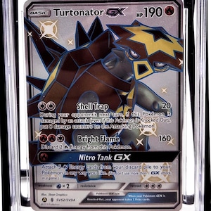 May include: A graded Pokémon card featuring Turtonator GX from the Hidden Fates set. The card is encased in a clear plastic holder and graded as Mint 9 by CGC. The card art depicts a brown and yellow dragon-like creature.