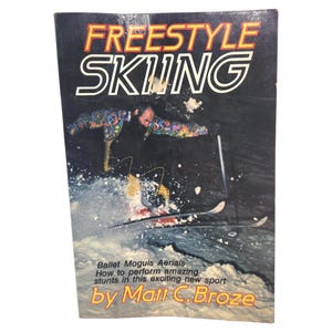 May include: A book cover titled "FREESTYLE SKIING" with a skier performing a stunt. The cover features the text "Ballet Moguls Aerials How to perform amazing stunts in this exciting new sport by Matt C. Broze."