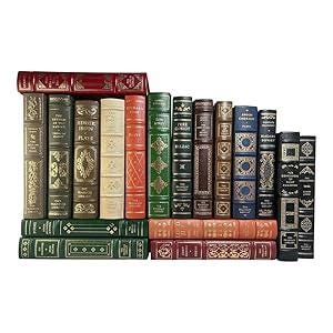 May include: A collection of antique books with various colors and designs. The books are arranged in two rows, with the top row displaying the spines and the bottom row showing the covers. The books have gold lettering and decorative patterns.