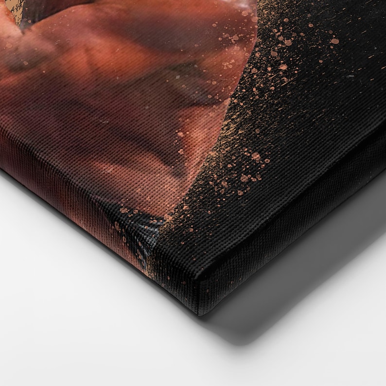 May include: Close-up of a canvas print with a textured surface. The print features a faded image of a person's torso with a splatter of gold paint.