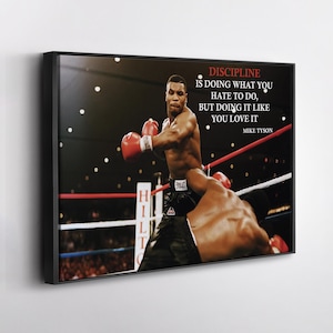 May include: Framed canvas art featuring a boxing match with Mike Tyson. The image shows Tyson in action, wearing red gloves, with the text "DISCIPLINE IS DOING WHAT YOU HATE TO DO, BUT DOING IT LIKE YOU LOVE IT" and "MIKE TYSON".