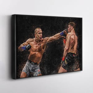 May include: Two men in a boxing ring, one wearing black shorts and the other wearing gray shorts, are in a fighting stance. The man in the gray shorts is throwing a punch with his right hand. The man in the black shorts is blocking the punch with his left arm. The background is a dark, blurry image of the crowd.