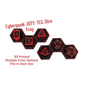 May include: Two black and red hexagonal dice trays with text reading Cyberpunk 2077: TCG Dice Tray, 3D Printed, Multiple Color Options, Fits in deck box. The trays hold various polyhedral dice including a d4, d6, d8, d10, d12, and d20.