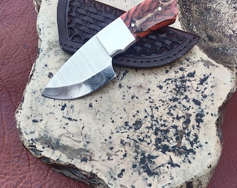 Custom handmade Damascus steel skinner knife with beautiful leather case.