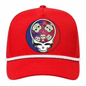 May include: A bright red baseball cap featuring a white braided cord across the base of the crown. The front displays a circular graphic with a white skull outline containing multiple small, light green monkey faces against a red and blue background.