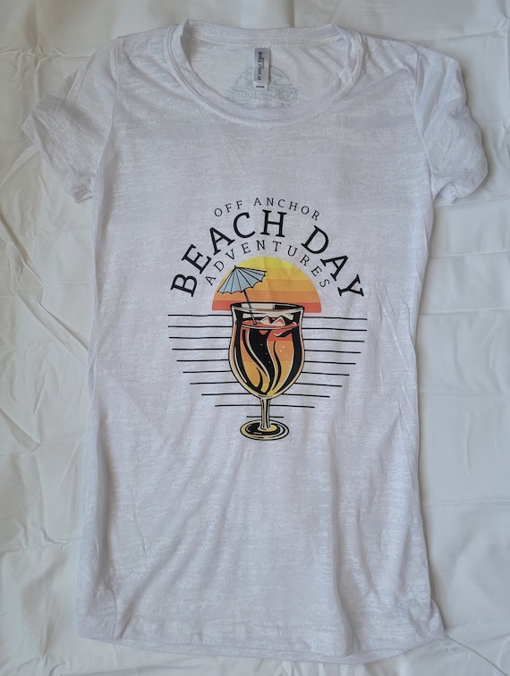 Women's burnout shirt with colorful beach logo.