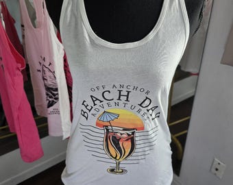 Women's white tank top with a beach theme logo on the front.