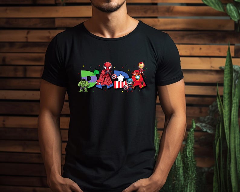 May include: Black t-shirt featuring the word "DAD" with superhero characters. The letter "D" has a green Hulk, the "A" has a Spider-Man, and the second "D" has Iron Man, Captain America, and other characters.