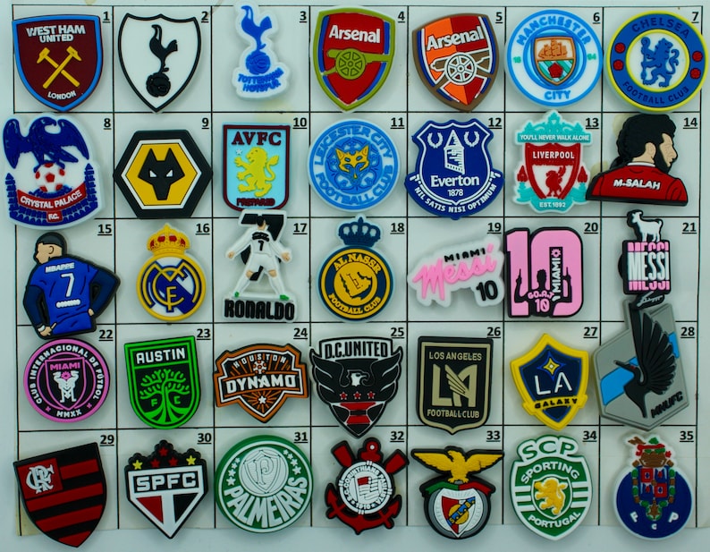 May include: A collection of 35 colorful, rubberized shoe charms featuring logos of various sports teams, including soccer, football, and basketball. The charms are arranged in a grid pattern on a white background.