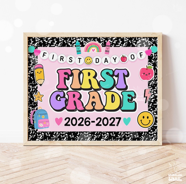 May include: A rectangular sign with a black and white composition notebook pattern border surrounding a light pink center. The text reads FIRST DAY OF FIRST GRADE 2026-2027. Graphics include a rainbow, smiley faces, a pencil, an apple, and a backpack.