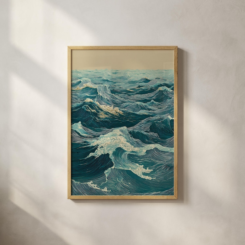 May include: A framed art print depicting a stylized ocean scene. The artwork features a dynamic composition of rolling waves in shades of teal and white, with a light beige sky. The print is encased in a natural wood frame.