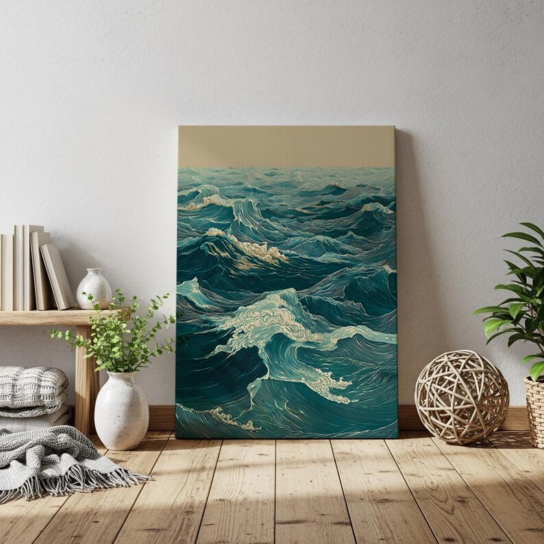 May include: Canvas art print depicting an ocean scene with stylized waves in shades of teal and white. The artwork has a vintage aesthetic, with a beige sky and detailed linework. The print is displayed in a room with wooden floors and decorative elements.