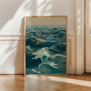 May include: A framed art print depicting a stylized ocean scene. The artwork features detailed waves in shades of teal, blue, and white, with a light beige sky. The wooden frame adds a natural touch to the nautical-themed print.