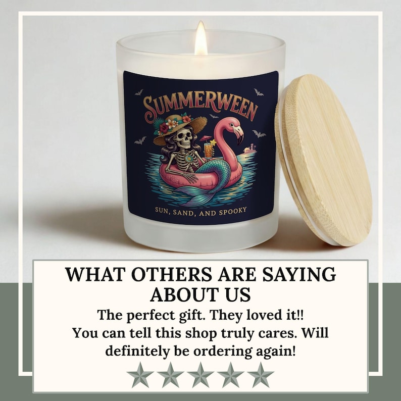 May include: A lit candle in a frosted glass jar with a wooden lid. The jar features a "Summerween" label with a skeleton on a flamingo float. The text "Sun, Sand, and Spooky" is also on the label.