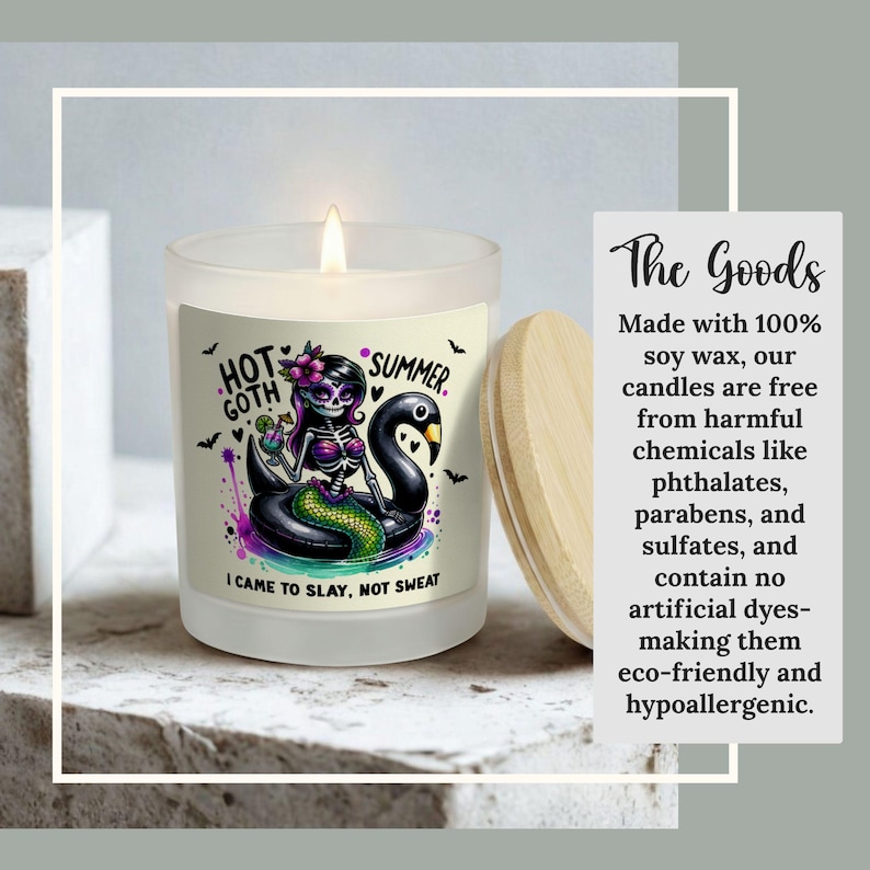 May include: A frosted glass candle with a wooden lid. The candle features a colorful illustration of a skeleton mermaid on a black swan float with the text "HOT GOTH SUMMER" and "I CAME TO SLAY, NOT SWEAT".