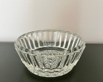 May include: A clear glass bowl with a fluted design and a textured base.