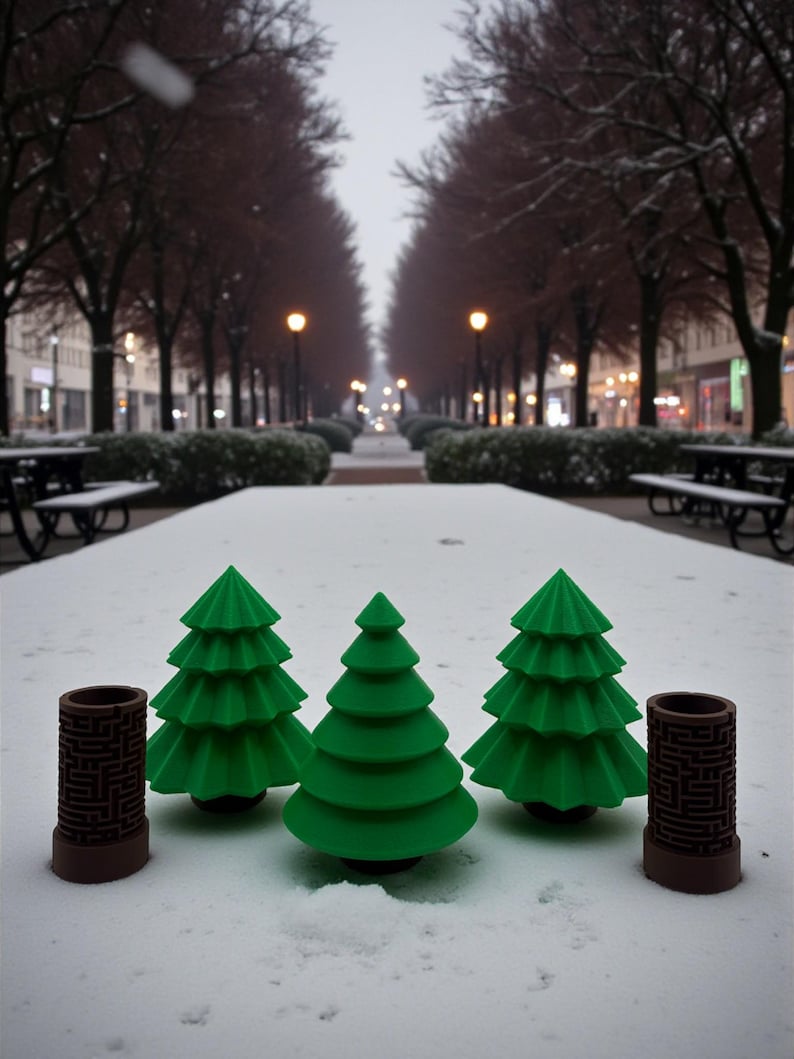 May include: Three green, stylized Christmas trees and two brown cylindrical objects with a maze pattern are arranged on a snow-covered surface. The background shows a snowy park with trees and streetlights.