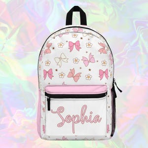 Sac à dos rose personnalisé avec noeuds et marguerites, joli sac à dos avec nom personnalisé, sac à dos urbain de tous les jours, sac à dos scolaire, beau sac à dos rose Coquet
