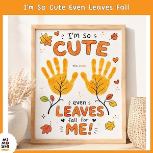May include: A framed wall art print featuring two yellow handprints stylized as autumn leaves. The text reads I'm so CUTE even LEAVES fall for ME! with the name Tim and the year 2026 printed in the centre, surrounded by small orange leaf illustrations.