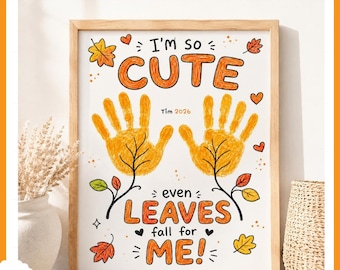 May include: A framed wall art print featuring two yellow handprints stylized as autumn leaves. The text reads I'm so CUTE even LEAVES fall for ME! with the name Tim and the year 2026 printed in the center, surrounded by small orange leaf illustrations.