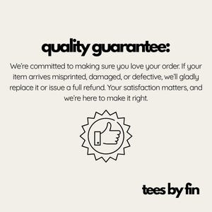 May include: Cream-colored graphic with the text "quality guarantee:" in black, followed by a guarantee statement. A thumbs-up icon is in a starburst shape. The brand name "tees by fin" is at the bottom.