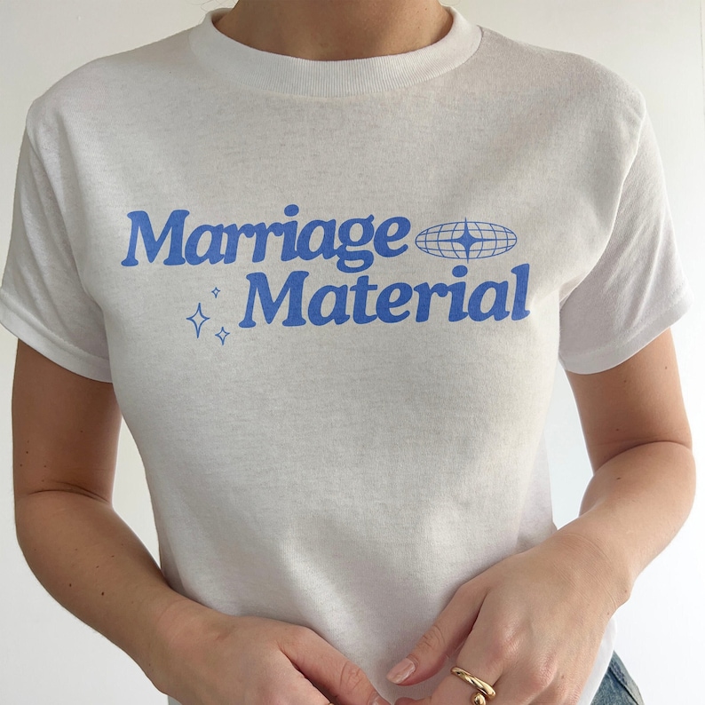 A female wears a boxy tee that says "marriage material" on a y2k baby tee
