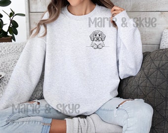 May include: A gray sweatshirt with a black and white illustration of a dog peeking out from the bottom of the pocket. The text "Marie & Skye" is printed on the sweatshirt.