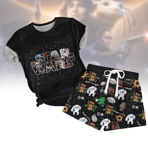 May include: A black t-shirt with the words "Star Wars" printed on it in white. The shirt is paired with black shorts featuring a repeating pattern of characters from the Star Wars universe.
