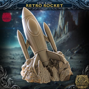 May include: A gold-colored retro rocket coin bank, with a textured surface, is perched on a rocky surface. The rocket has a large, round window and two side fins. The background is a dark blue sky with stars.