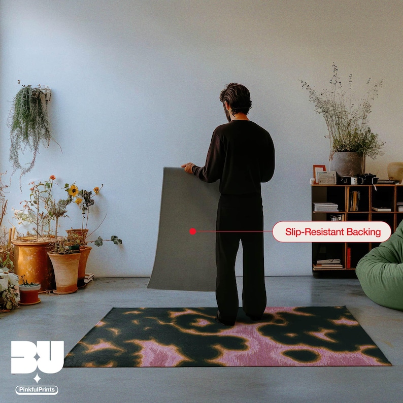 Person holding and showing the back of the rug with a slip-resistant backing showcase in a living room, highlighting a demonstration of the dark green, pink and yellow animal print faux tufted texture printed area rug for the eclectic home.
