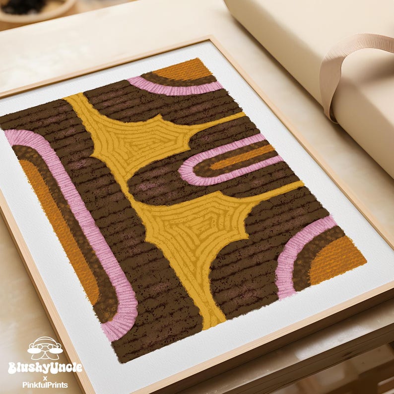 Wood-framed yellow, pink and brown eclectic retro rug art print— the geometric textile painting resembles a tufted rug texture textile wall art decor, Bauhaus poster placing on wood table for dorm room essentials.