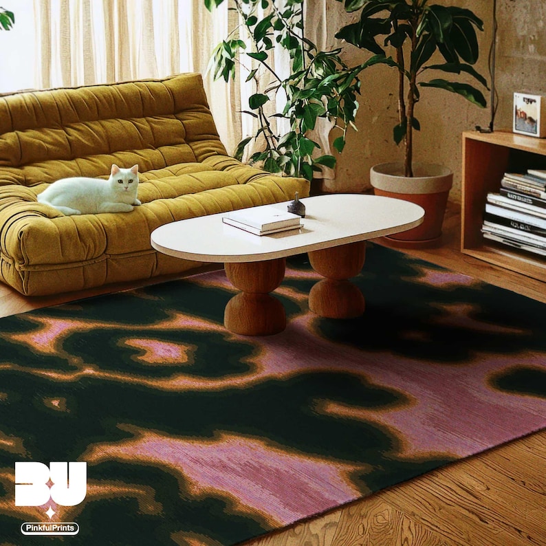 A colorful vivid area rug 5x7 featuring dark green and pink abstract cowhide animal print pattern and placed on the wood floor in a cozy living room, with coffee table on top of it and a mustard yellow togo sofa with a cat laying on it.