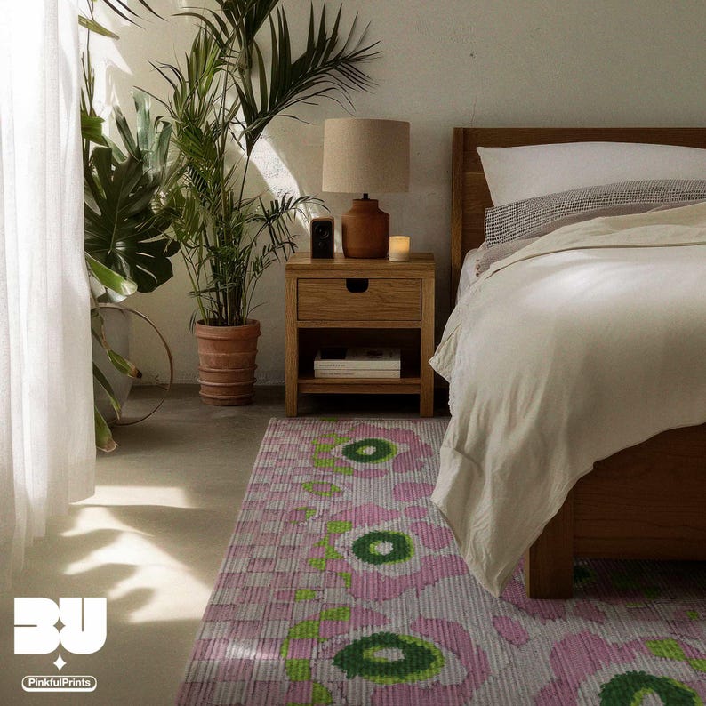 Cozy bedroom minimalist interior with wooden furniture, potted plants, and a colorful pastel pink floral flower market pattern, abstract leopard pattern, green checkered patterns area rug underneath the bed.