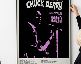 May include: Black and white concert poster advertising a Chuck Berry performance at Kleinhan's Music Hall in Buffalo, New York on March 23rd, 1969. The poster features a silhouette of Chuck Berry playing a guitar. The text on the poster includes the date, time, venue, and ticket information.
