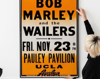 May include: A vintage concert poster advertising a Bob Marley and the Wailers concert on Friday, November 23rd at the Pauley Pavilion in UCLA. The poster is orange and white with black text.