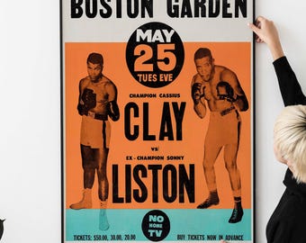 May include: A vintage boxing poster advertising a fight between Cassius Clay and Sonny Liston at Boston Garden on May 25th, 1965. The poster features a photo of each boxer in the ring, with the text "WORLD HEAVYWEIGHT CHAMPIONSHIP" at the top and "TICKETS: $50.00, 30.00, 20.00" at the bottom.