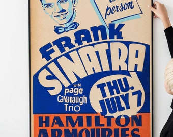 May include: A vintage concert poster advertising Frank Sinatra performing in person on Thursday, July 7th at the Hamilton Armouries. The poster features a blue and white illustration of Sinatra's face and the text "with page Cavanaugh Trio."