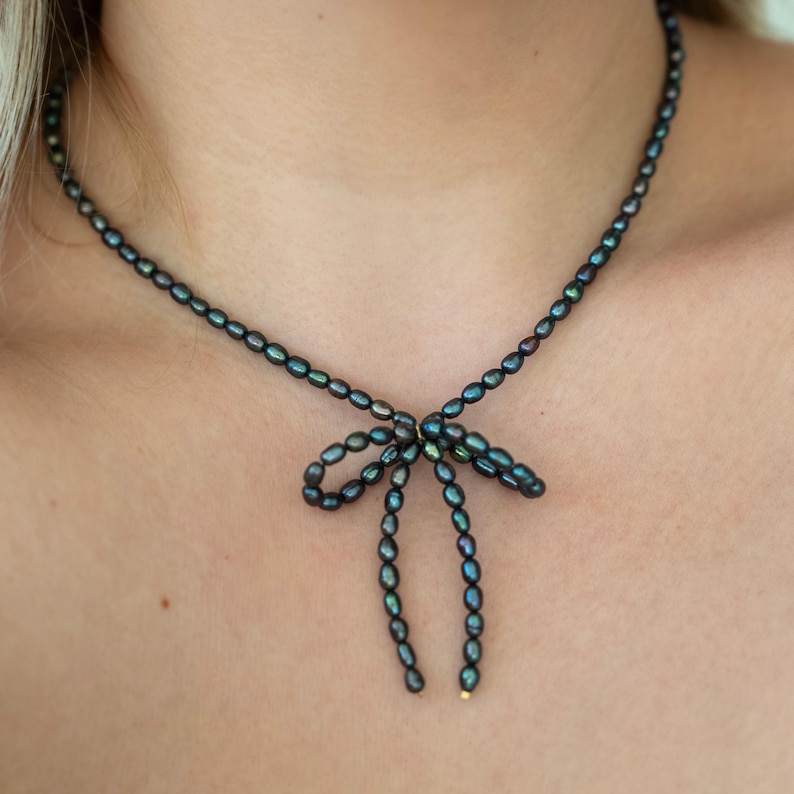 Cute black pearl necklace choker showcased on a model.