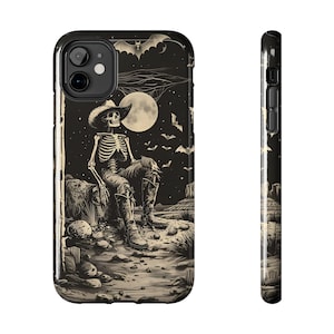 May include: A black and white illustration of a skeleton wearing a cowboy hat and boots, sitting on a rock in a desert landscape. The background features a full moon and bats flying in the night sky.
