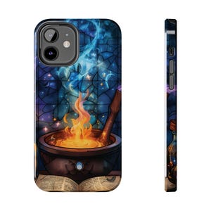 May include: A phone case with a stained glass design featuring a cauldron with a blue and purple flame, surrounded by stars and a book.