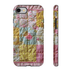 May include: A phone case with a patchwork design featuring pink, yellow, and blue floral fabric. The case has a black border and a pink and white checkered trim.