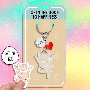 May include: A silver keychain with a cartoon character, a red heart charm, and a silver charm with the letter "M". The keychain is on a card that says "Open the door to happiness".