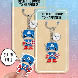Op de afbeelding: Twee Captain America sleutelhangers met een zilveren sleutelring en een zilveren bedel met de letter A. De hangers bevinden zich op een witte kaart met de tekst "Open de deur naar geluk" en "Haal me gratis!"
