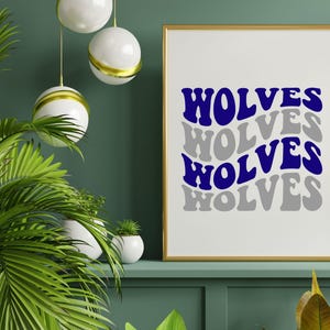 May include: A framed print with the word "WOLVES" in blue and grey, repeated in a wavy design. The gold-framed artwork is displayed on a green shelf, with green plants in the foreground.