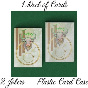 May include: A deck of cards featuring a Taurus zodiac design. The cards have a green, gold, and brown color scheme, with a bull illustration and the word "Taurus". Includes a plastic card case and 2 jokers.