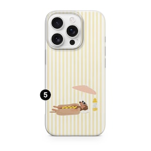 May include: A phone case with a yellow and white striped background. The case features a cartoon hot dog wearing sunglasses and relaxing under a pink umbrella. A bottle of sunscreen is also visible.