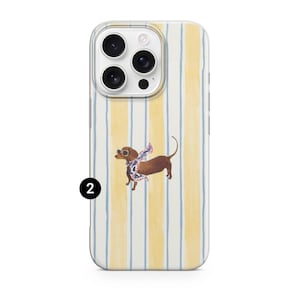 May include: Clear phone case with a vertical striped pattern in yellow and blue. A brown dachshund wearing sunglasses and a patterned scarf is featured on the case. The number 2 is printed in black on the bottom left.