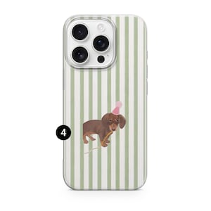 May include: A clear phone case with a vertical green and white striped pattern. The case features a watercolor illustration of a brown dachshund wearing a pink party hat and holding a yellow stick.