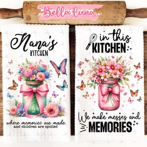May include: Two white kitchen towels with floral designs and text. The first towel says "Nana's Kitchen" and "where memories are made and children are spoiled". The second towel says "in this kitchen: We make messes and MEMORIES".